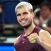 Carlos Alcaraz has a tennis ball in his hand japan open alcaraz taylor fritz