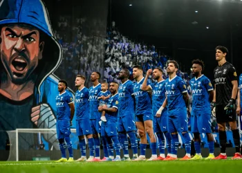 Al Hilal players celebrate at the Kingdom Arena after a dominant 3-0 victory over Al Hazem, a result that moves them four points clear at the top of the table.