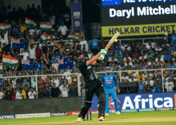 Action in Indore: Mitchell Powers Through New Zealand’s Daryl Mitchell plays a commanding shot during the high-stakes new zealand vs india 3rd ODI at the Holkar Cricket Stadium.