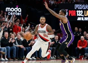 A Portland Trail Blazers guard drives against a Los Angeles Lakers defender during the trail blazers vs lakers game at the Moda Center on January 18, 2026, which ended in a 132-116 victory for Portland.