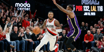 A Portland Trail Blazers guard drives against a Los Angeles Lakers defender during the trail blazers vs lakers game at the Moda Center on January 18, 2026, which ended in a 132-116 victory for Portland.