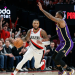 A Portland Trail Blazers guard drives against a Los Angeles Lakers defender during the trail blazers vs lakers game at the Moda Center on January 18, 2026, which ended in a 132-116 victory for Portland.