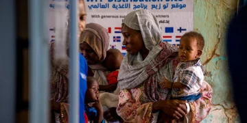 Families displaced by Sudan famine 2026 waiting for WFP food distribution